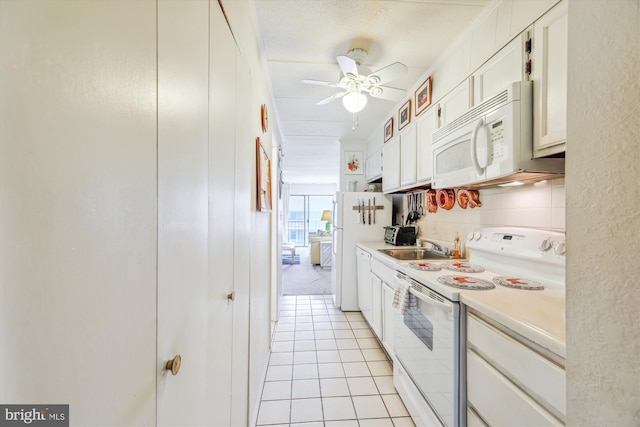 kitchen featuring ornamental molding, white cabinetry, light tile patterned floors, white appliances, and ceiling fan