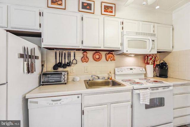 kitchen featuring decorative backsplash, white appliances, sink, and white cabinets