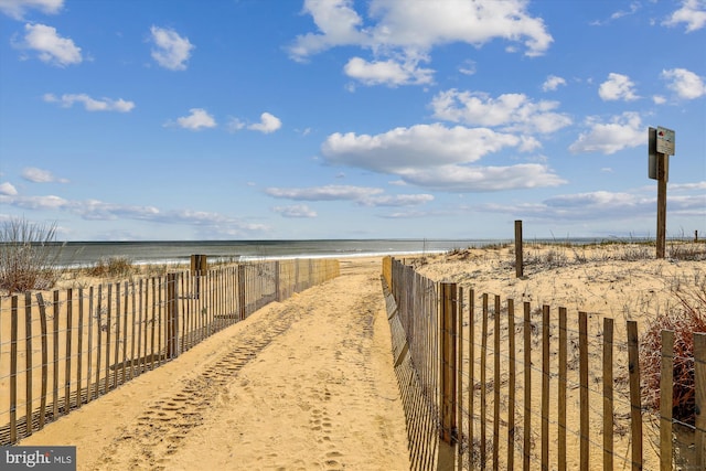 exterior space featuring a view of the beach and a water view