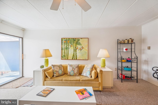 carpeted living room featuring ceiling fan, a healthy amount of sunlight, and a textured ceiling