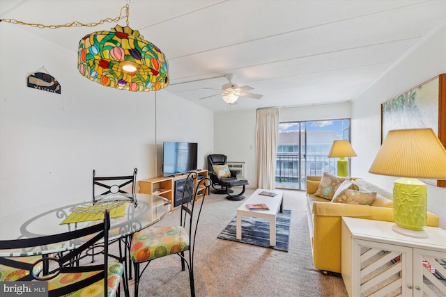 carpeted living room with ceiling fan