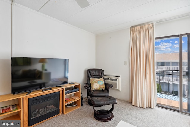 living area with a wall unit AC, carpet floors, ceiling fan, and crown molding