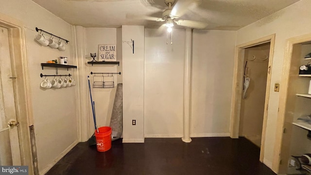 basement featuring dark hardwood / wood-style flooring and ceiling fan