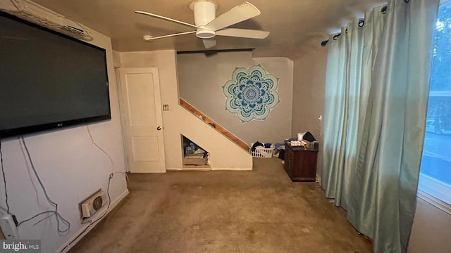 interior space featuring ceiling fan and carpet