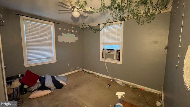 empty room featuring ceiling fan and cooling unit