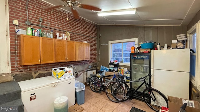 interior space with white refrigerator, ceiling fan, and refrigerator