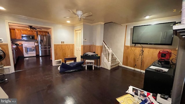 living room featuring ceiling fan, crown molding, and dark hardwood / wood-style flooring