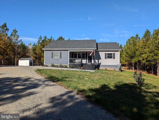 ranch-style home with a storage unit, covered porch, and a front yard