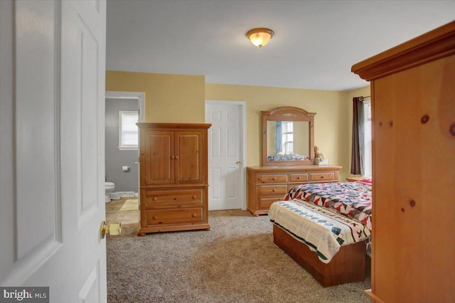 carpeted bedroom with ensuite bathroom