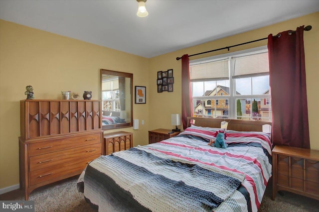 carpeted bedroom featuring multiple windows