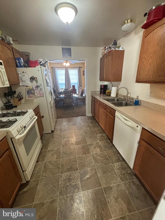 kitchen featuring white appliances and sink