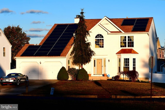 view of front of house featuring a garage and solar panels