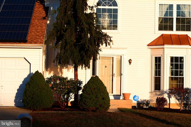 view of exterior entry featuring a garage