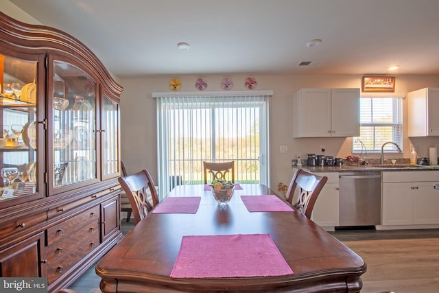 dining room with sink and light hardwood / wood-style flooring