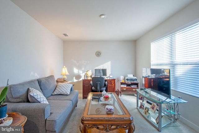 living room with a wealth of natural light and light carpet