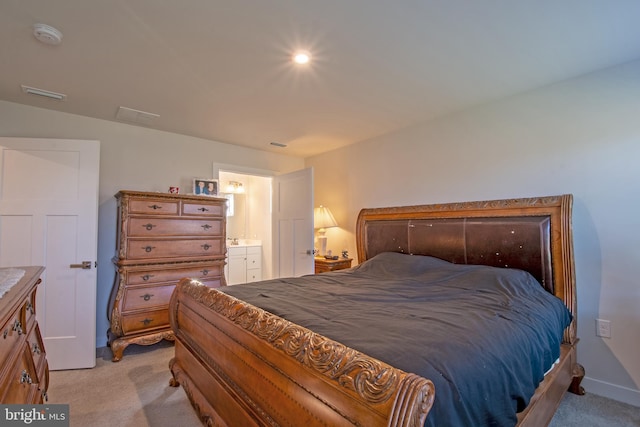 carpeted bedroom with connected bathroom