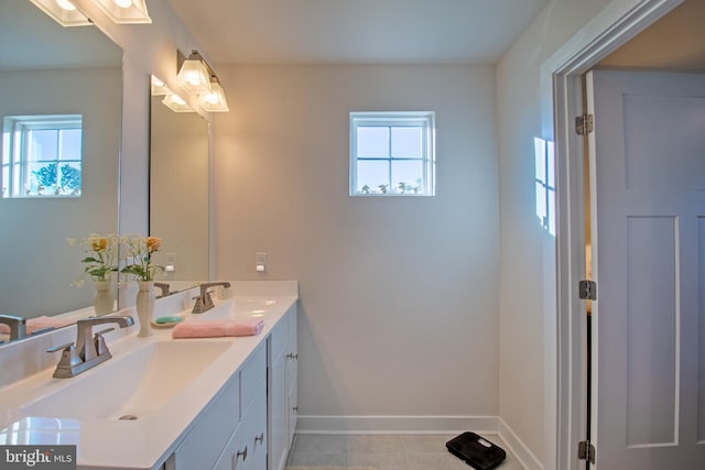 bathroom featuring a wealth of natural light, vanity, and tile patterned floors