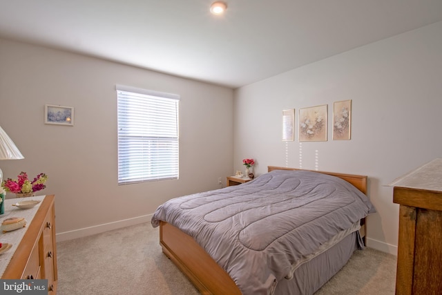 bedroom featuring light colored carpet