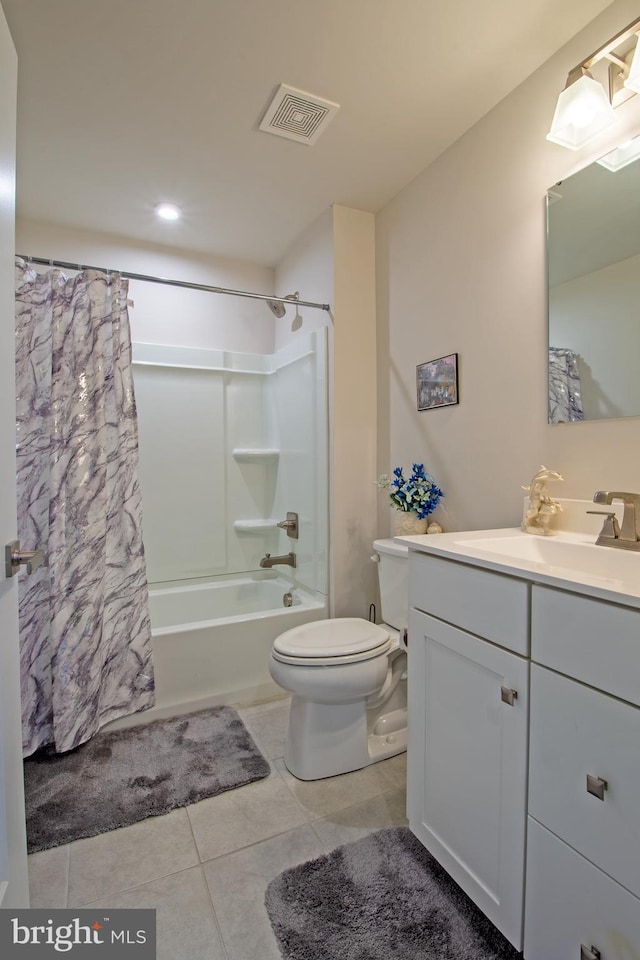 full bathroom featuring toilet, vanity, tile patterned flooring, and shower / bathtub combination with curtain