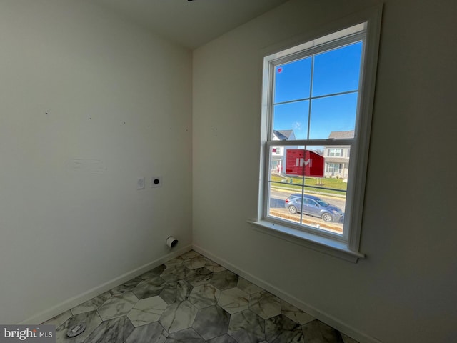 washroom with hookup for an electric dryer