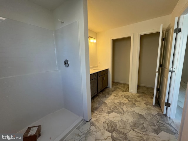 bathroom with walk in shower and vanity