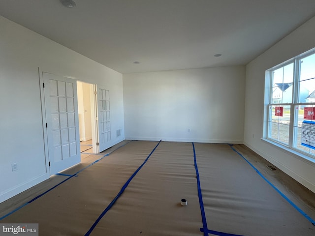 empty room with hardwood / wood-style flooring