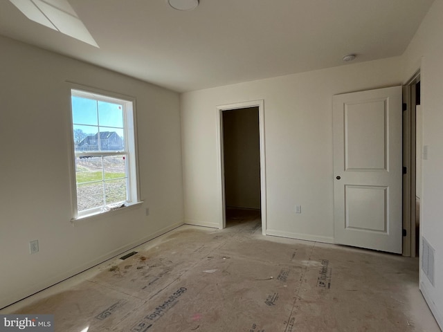 unfurnished bedroom featuring a spacious closet