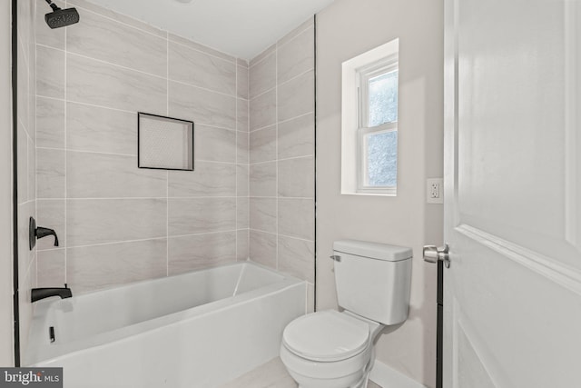 bathroom featuring toilet and tiled shower / bath combo