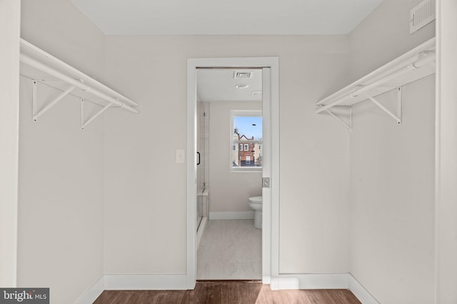 walk in closet featuring wood-type flooring