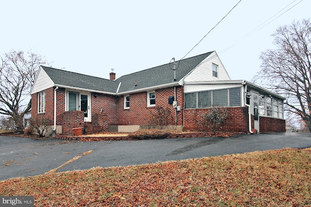 view of front facade with a sunroom