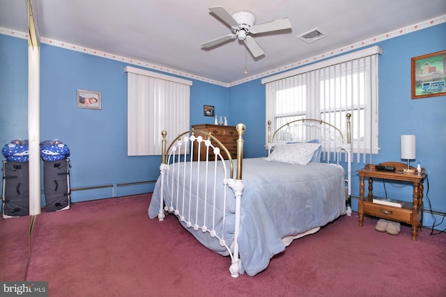 bedroom with carpet, ceiling fan, and a baseboard heating unit