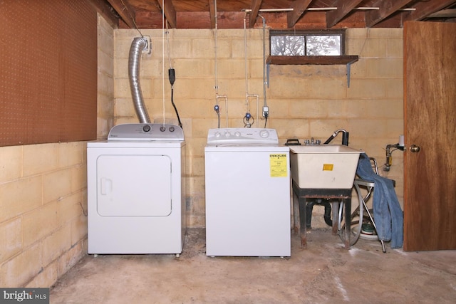 washroom featuring washing machine and clothes dryer and sink