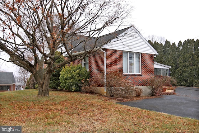 view of property exterior featuring a lawn