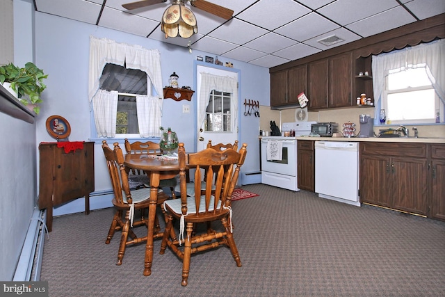 kitchen with white appliances, dark brown cabinetry, sink, dark colored carpet, and a baseboard radiator