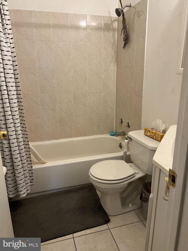 full bathroom with tile patterned flooring, shower / bath combo with shower curtain, vanity, and toilet