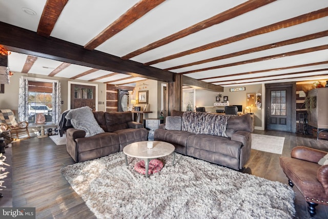 living room featuring beamed ceiling and dark hardwood / wood-style floors