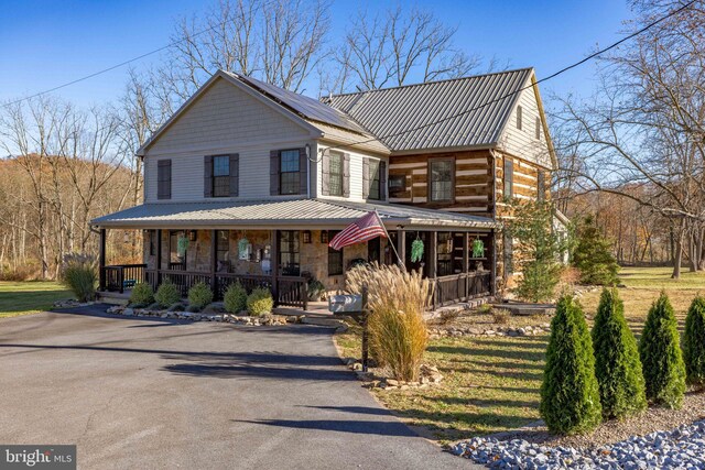 3204 State Route 72, Jonestown, PA 17038 - view of front of house featuring a porch, stone siding, solar panels, and metal roof