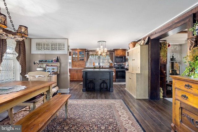 interior space featuring dark wood-type flooring, sink, and an inviting chandelier