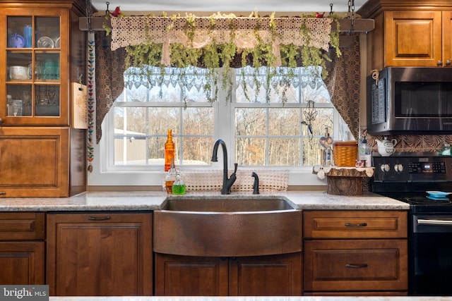3204 State Route 72, Jonestown, PA 17038 - kitchen featuring stainless steel microwave, black range with electric stovetop, a sink, brown cabinets, and glass insert cabinets