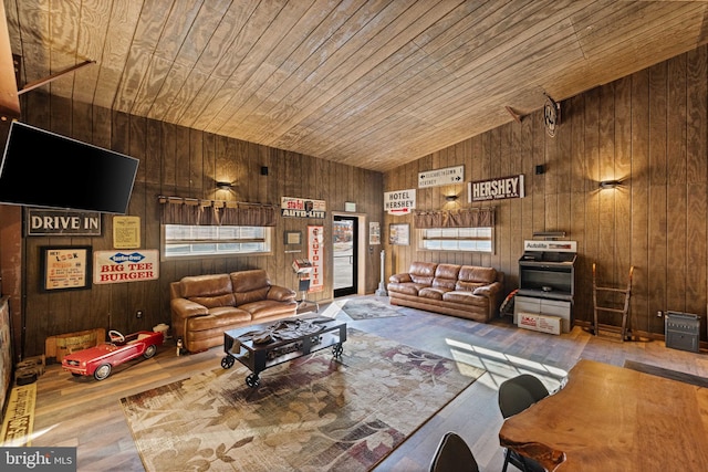 living room with wood walls, wood ceiling, hardwood / wood-style flooring, and vaulted ceiling