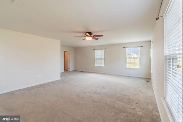 spare room with light colored carpet and ceiling fan