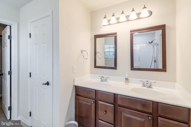 bathroom featuring vanity and a shower with shower door