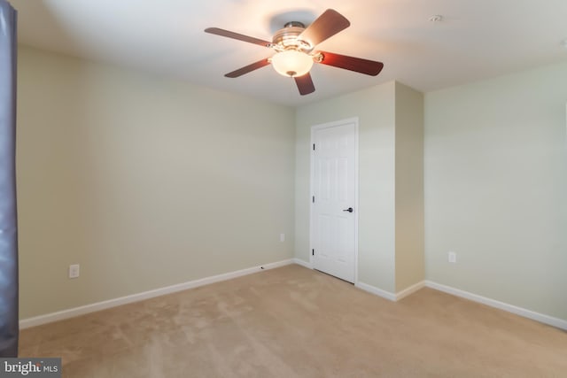 spare room with light carpet and ceiling fan