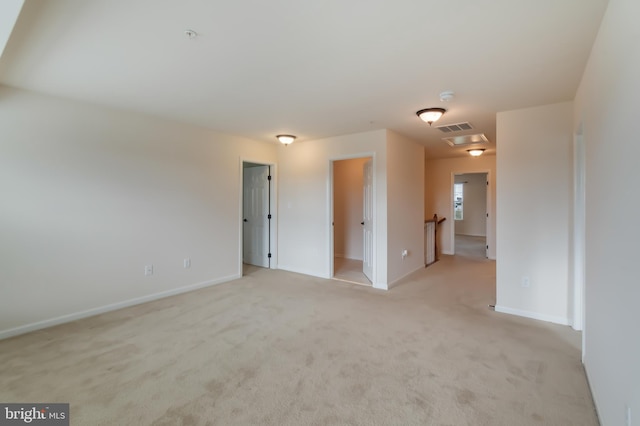 spare room featuring light colored carpet