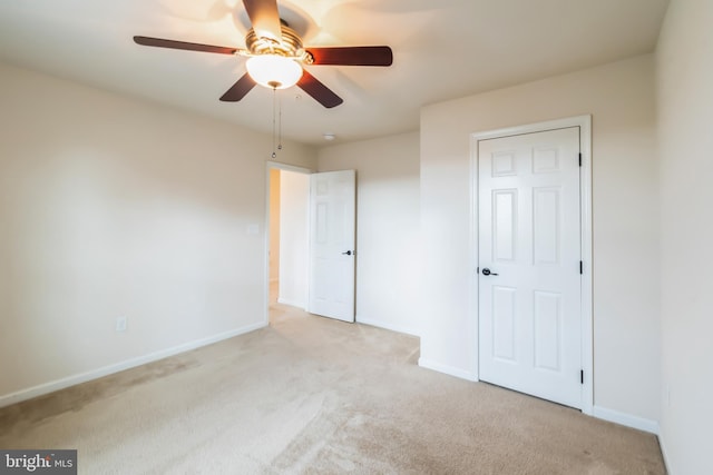 unfurnished bedroom with light colored carpet and ceiling fan