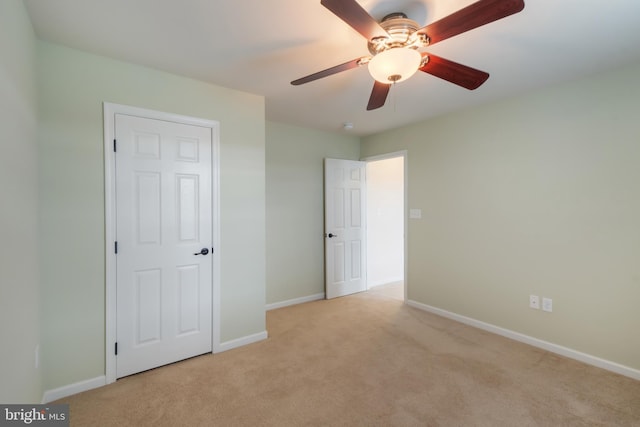 unfurnished bedroom with light carpet and ceiling fan