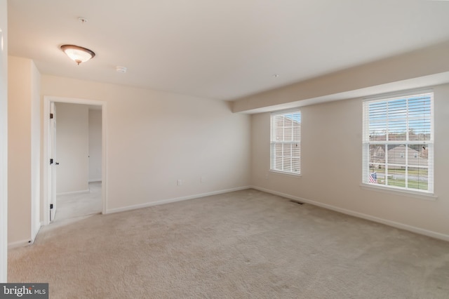 unfurnished room with light carpet