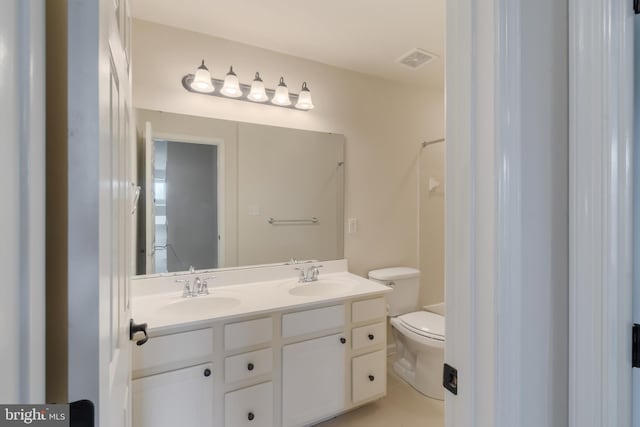 bathroom with toilet and vanity