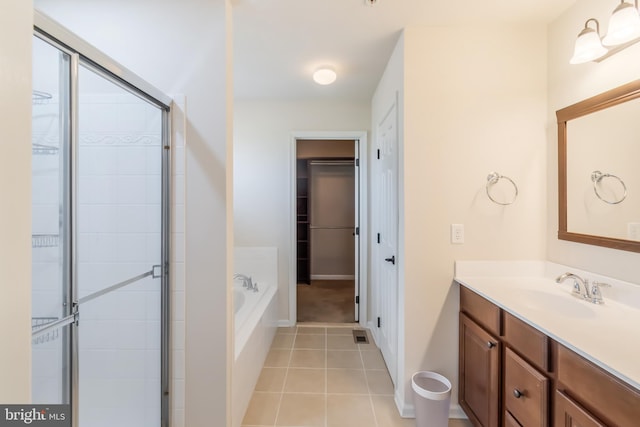 bathroom featuring tile patterned flooring, vanity, and independent shower and bath