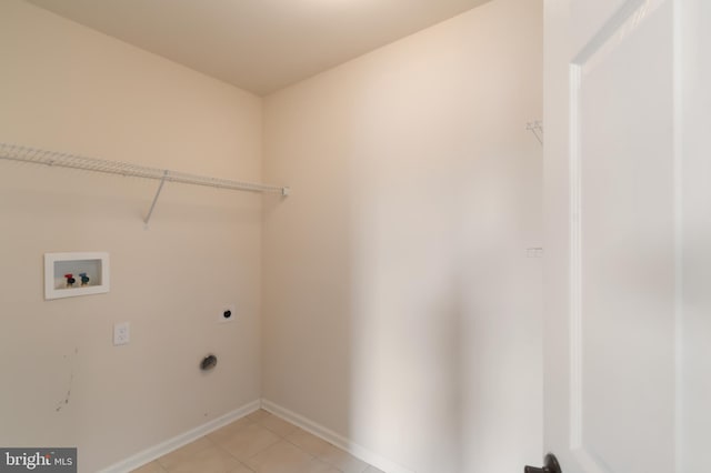 clothes washing area with washer hookup, electric dryer hookup, and light tile patterned floors